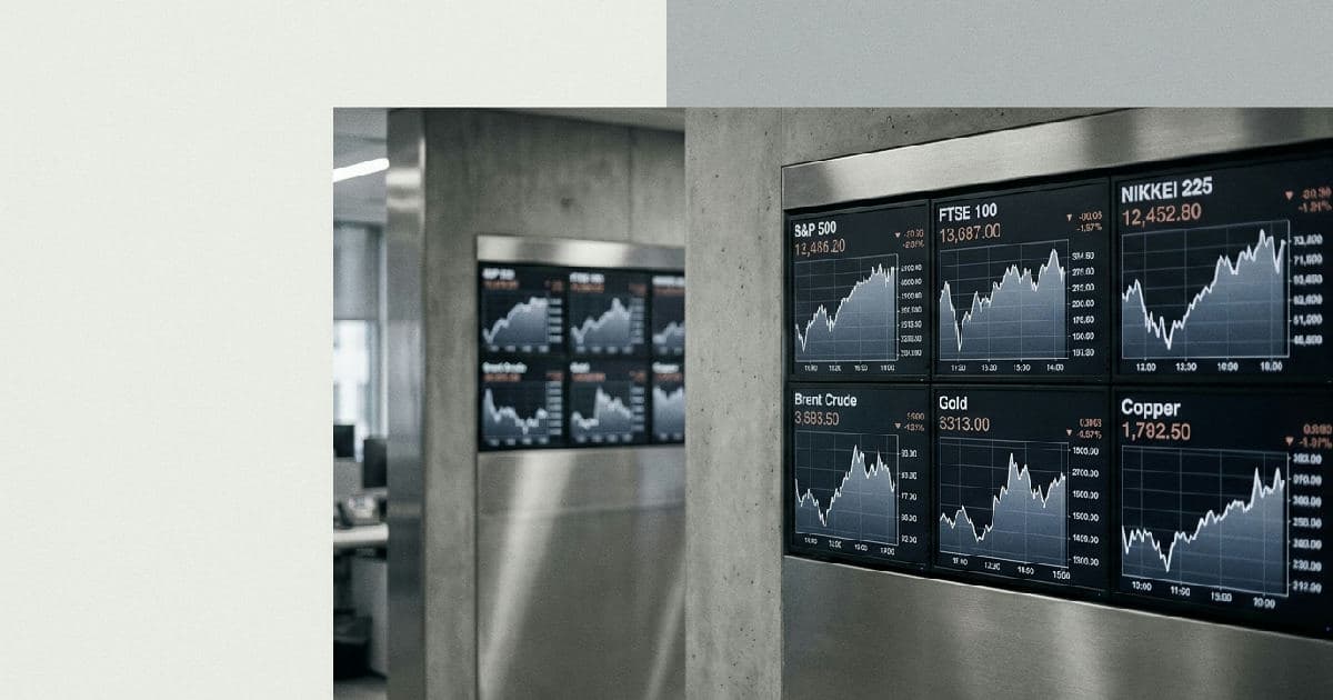 Financial market data screens showing commodity price charts and trading information in muted tones.