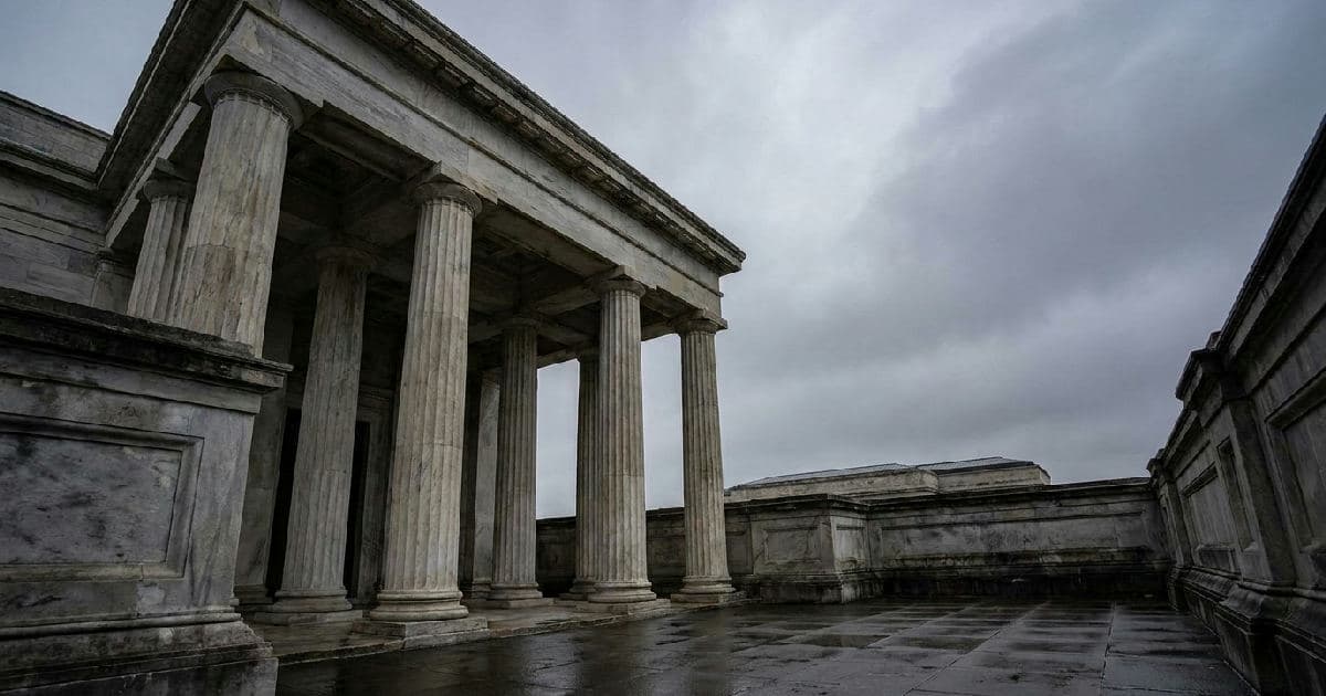 Classical marble columns of a government building under overcast sky, no people visible.
