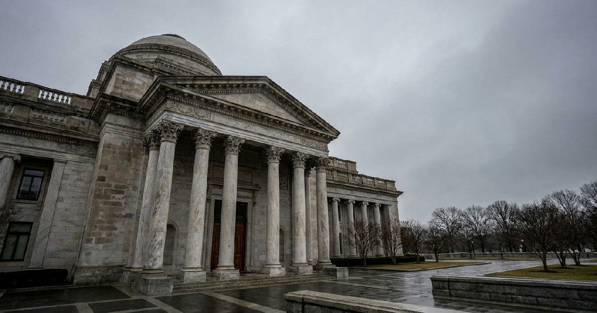 Classical government building with marble columns under overcast sky, no people visible.