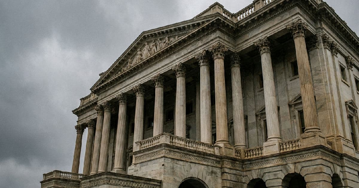 Classical marble columns of government building exterior beneath overcast sky, no people visible.