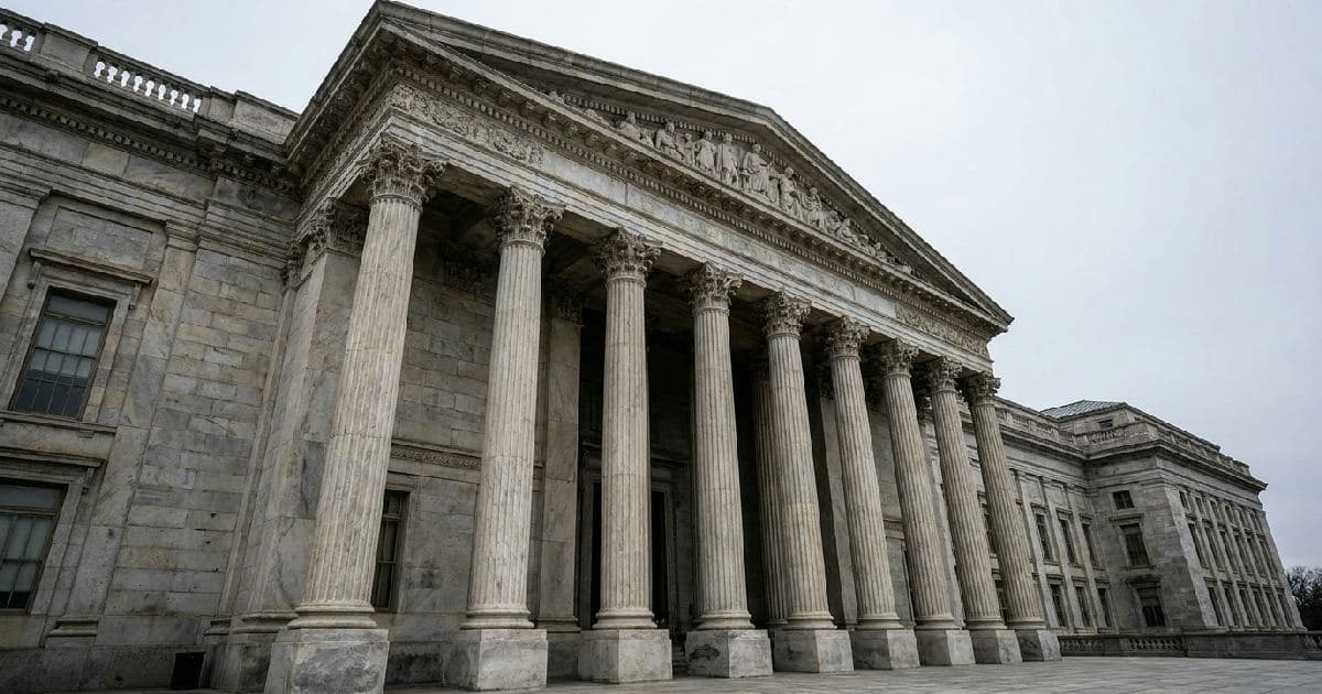Classical marble columns of a government building under overcast sky, architectural detail shot.