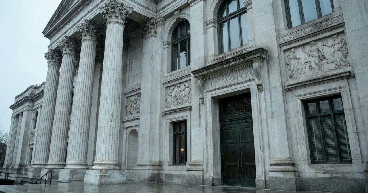 Classical marble columns of a government building under overcast sky, architectural detail.