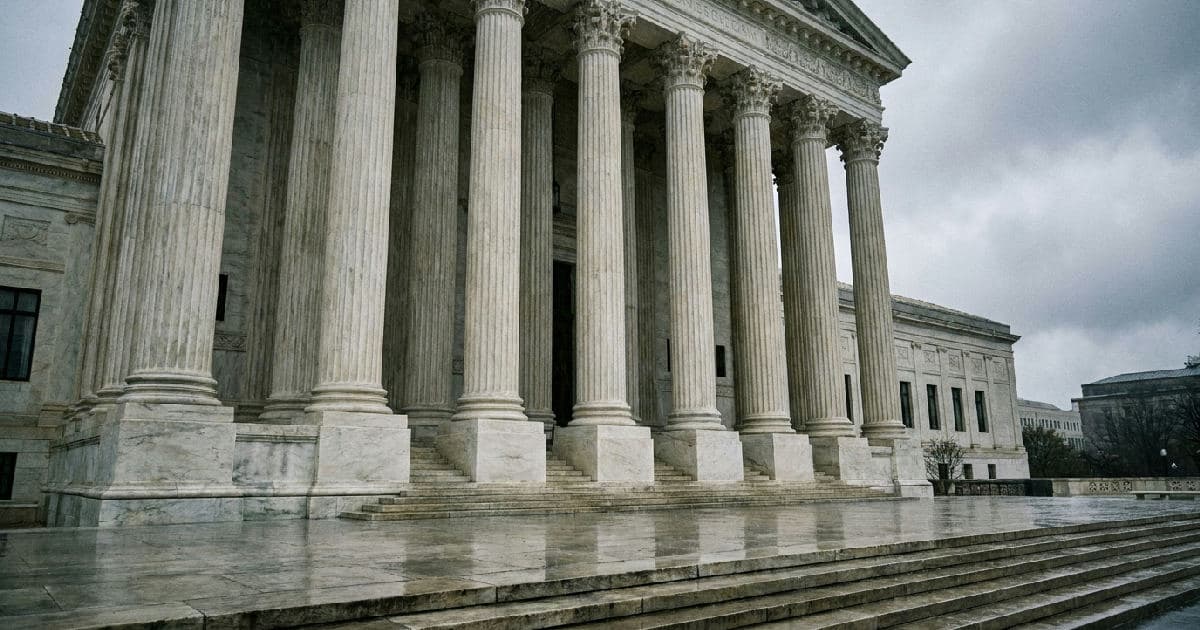 Classical marble columns of a government building under overcast sky, architectural composition with empty foreground.