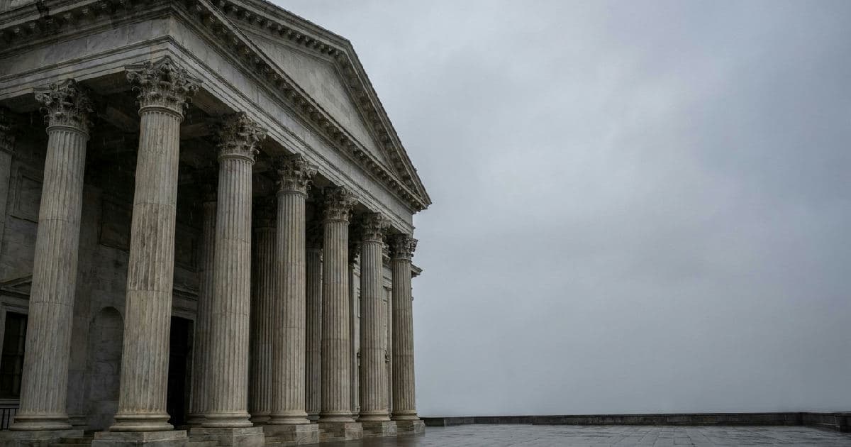 Classical marble columns of a government building under overcast sky, architectural composition.