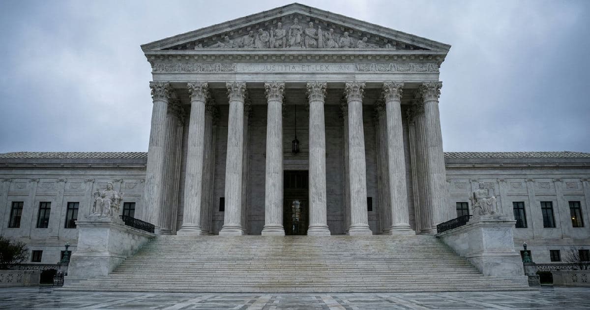 Marble columns of a government building beneath overcast sky, classical architecture symbolizing legal institutions.