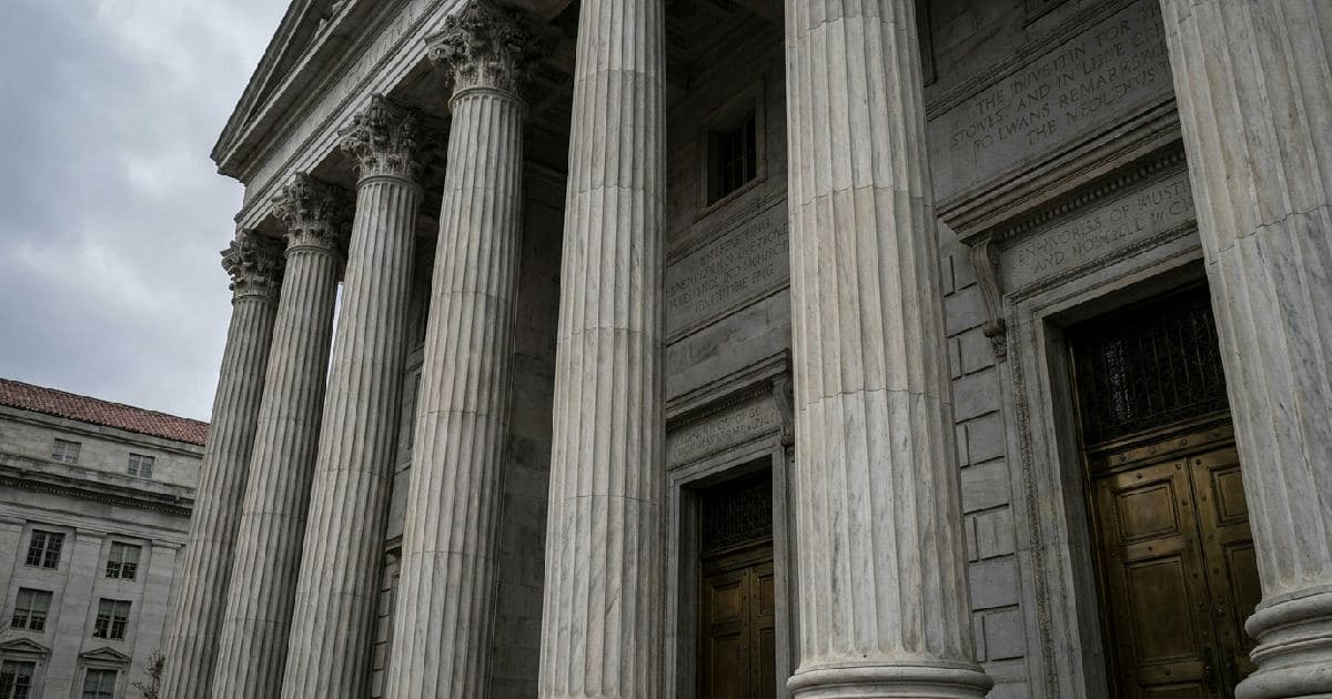 Classical marble columns of government building beneath overcast sky, no figures visible.