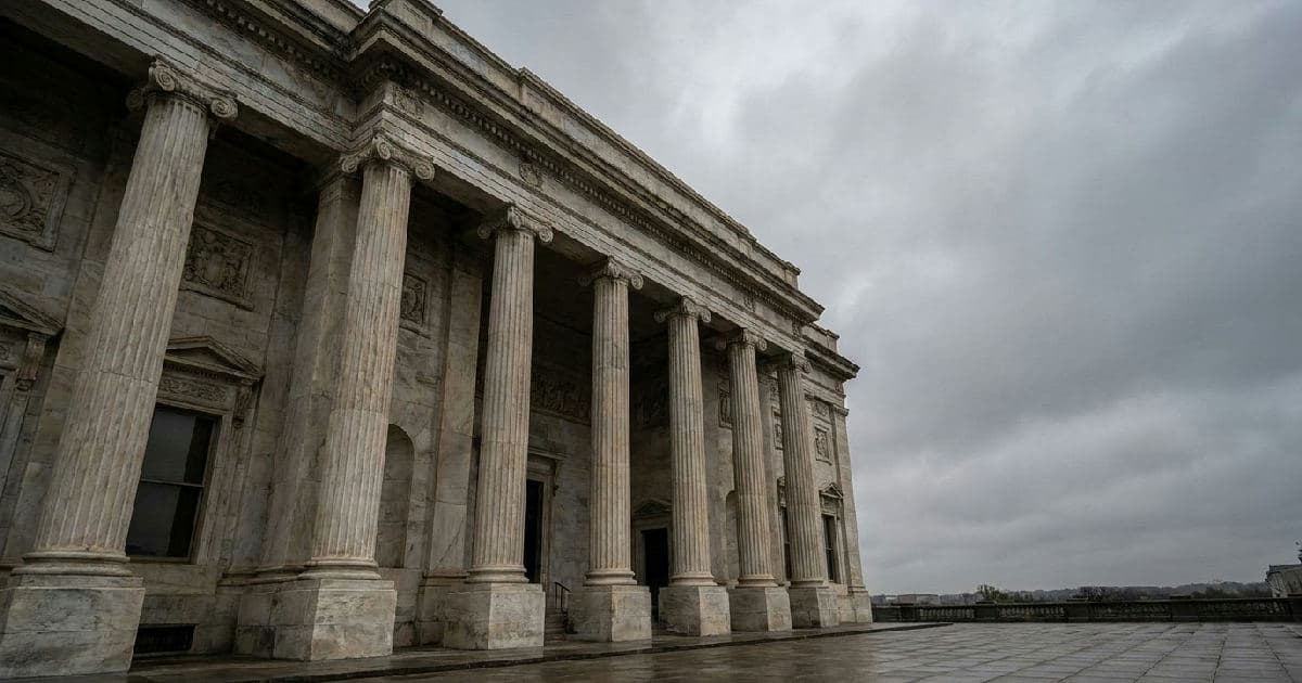 Classical marble columns of a government building under overcast sky, no people visible.