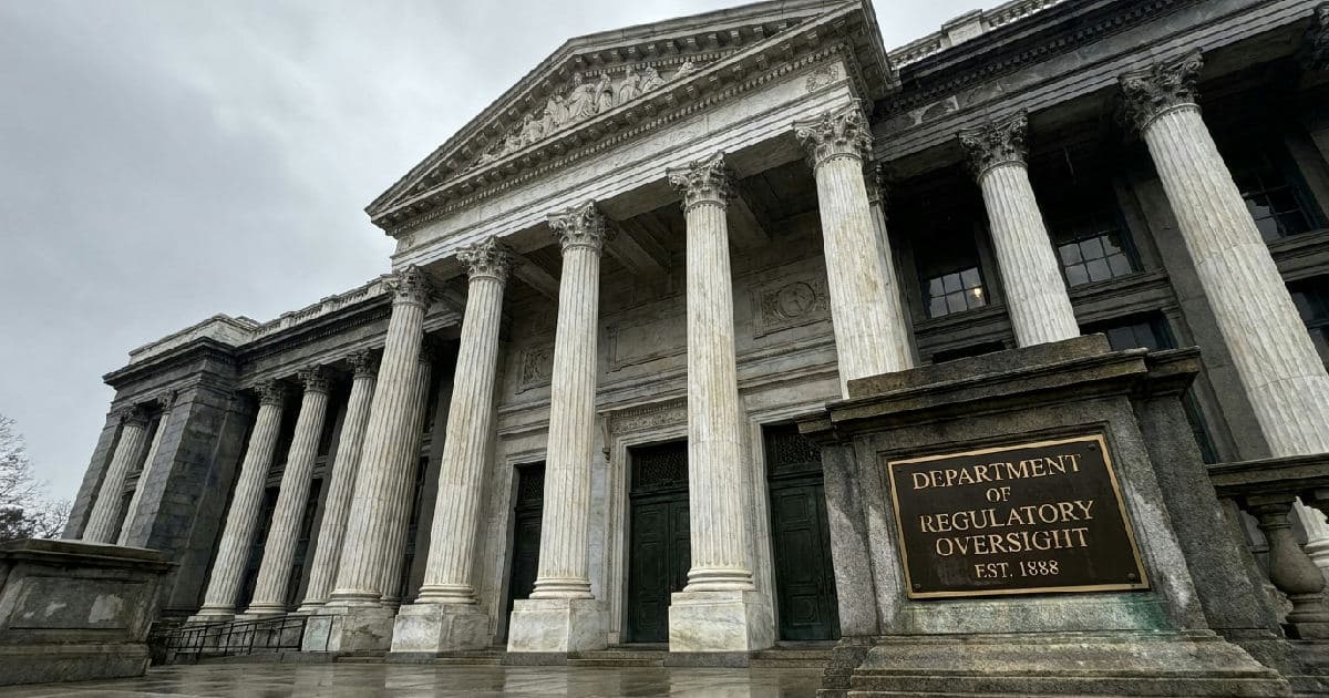 Classical marble columns of a government building under overcast sky, symbolizing regulatory oversight.