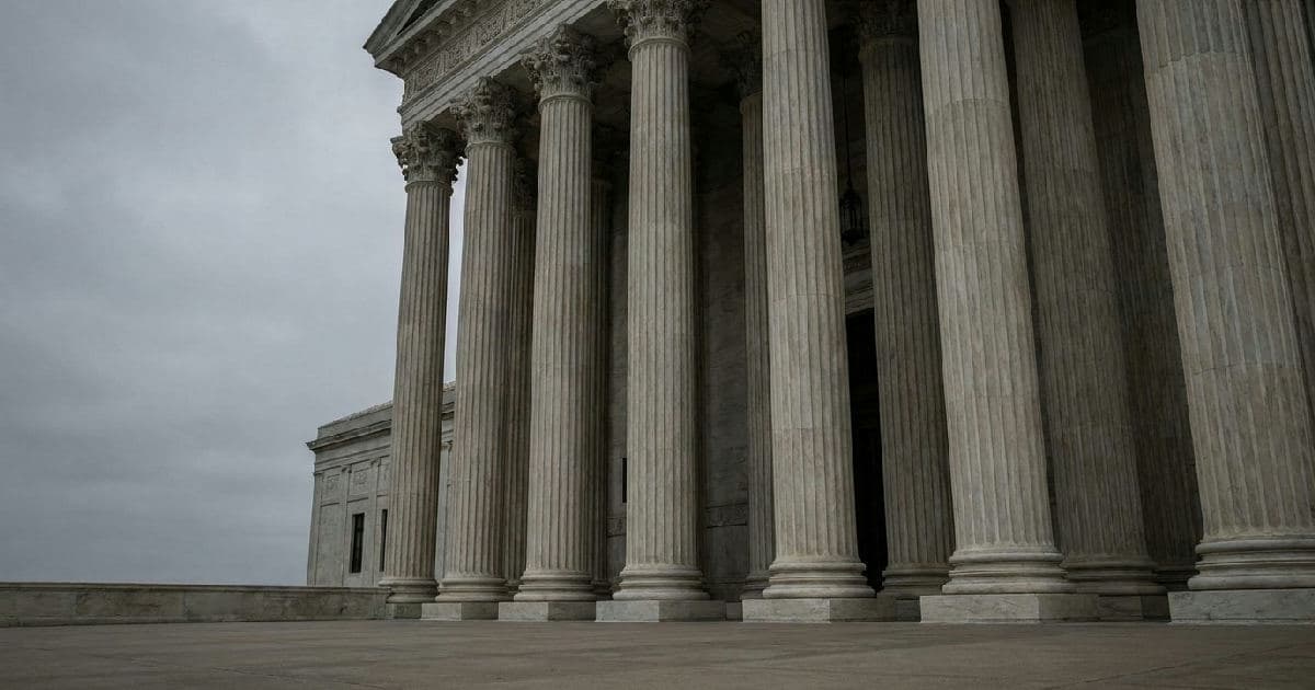 Classical marble columns of a government building against overcast sky, no people visible.