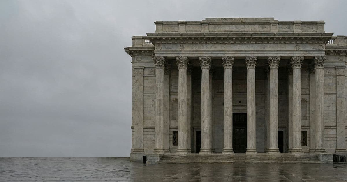 Classical marble columns of government building under overcast sky, architectural symmetry