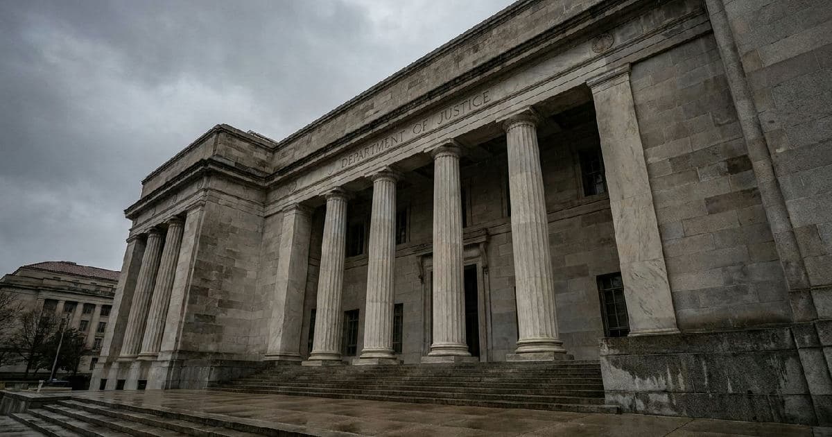 Classical marble columns of a government building exterior beneath overcast sky.